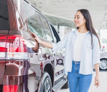Person inspecting a pre-owned vehicle in a lot — Used Car options for Australians with credit challenges