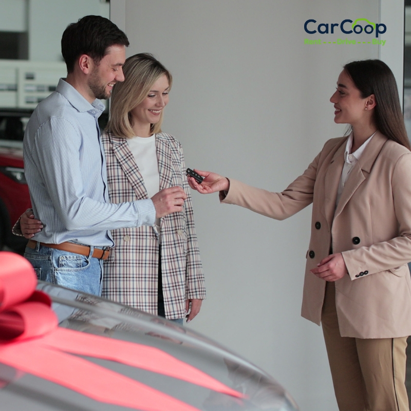 Car dealership consultant handing keys to a smiling couple, showcasing Rent-to-Own Cars in Adelaide with flexible ownership options.