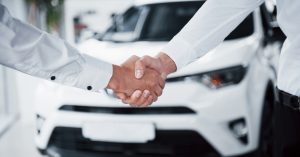 Car finance approval handshake despite BNPL usage and credit assessment