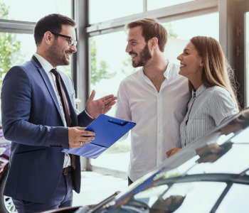 How Does Car Leasing Work in Australia? A couple discusses vehicle leasing options with a car consultant.